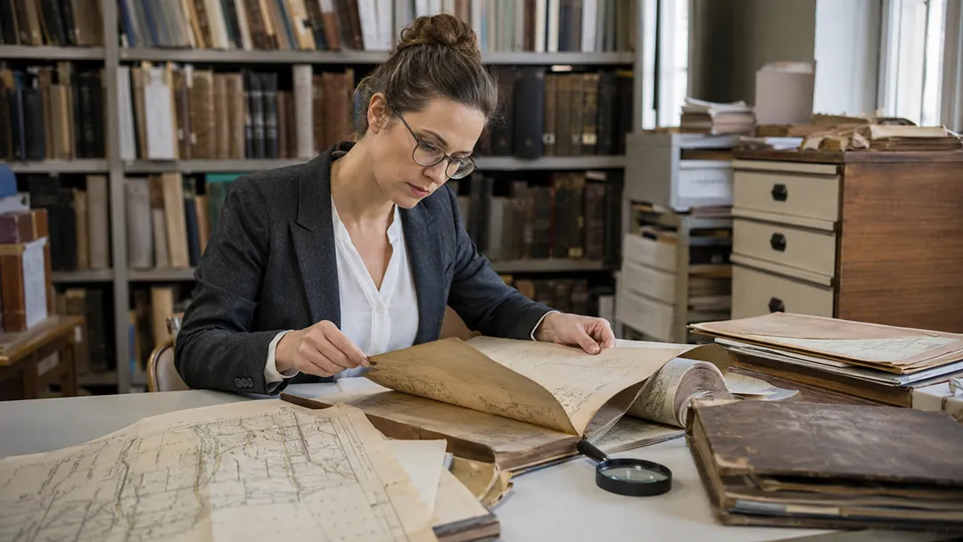 abandoned-mineral-rights-professional-land-researcher-reviewing-historical-property-records-in-a-county-recorder-office